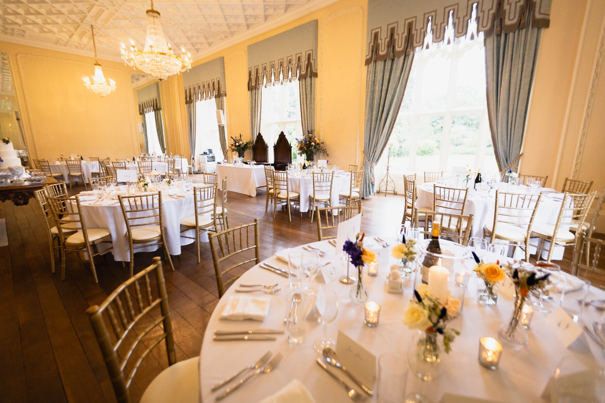 A wedding dinner room set for the reception at an Azoos Events celebration