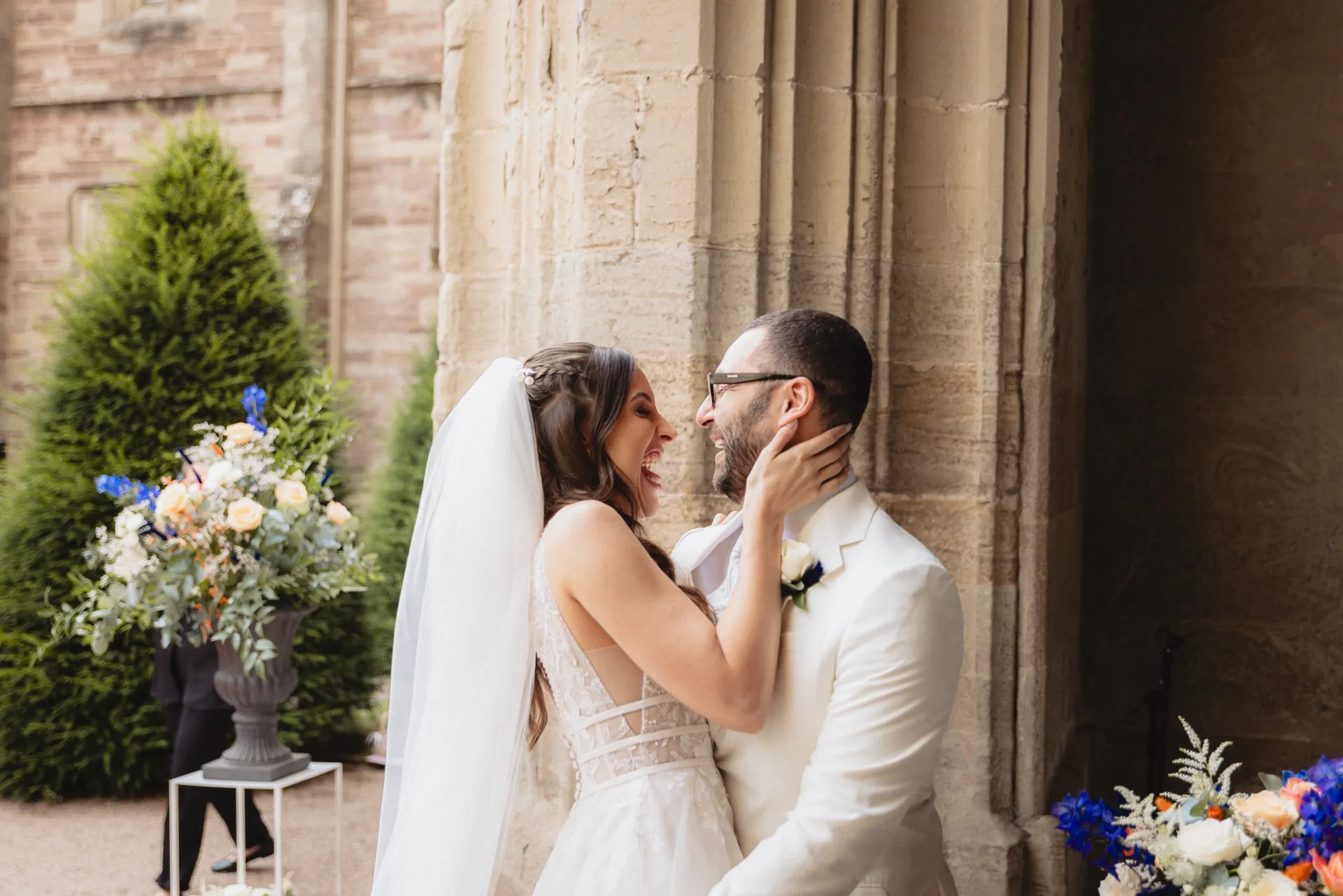 Bride and groom beneath a floral arch at an Azoos Events wedding